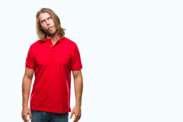 Fototapeta premium Young handsome man with long hair over isolated background making fish face with lips, crazy and comical gesture. Funny expression.