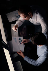 top view .two employees analyze the financial chart