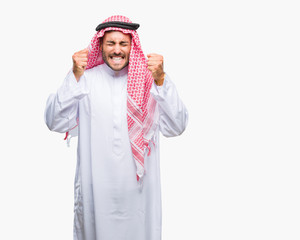 Young handsome man wearing keffiyeh over isolated background excited for success with arms raised celebrating victory smiling. Winner concept.