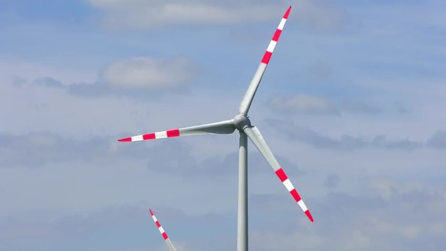 4K footage of wind turbines (aerofoil-powered generators) creating renewable energy. Arrays of large turbines, known as wind farms, are becoming an increasingly important source of renewable energy.