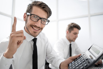 young accountant holding a thumb up and smiling