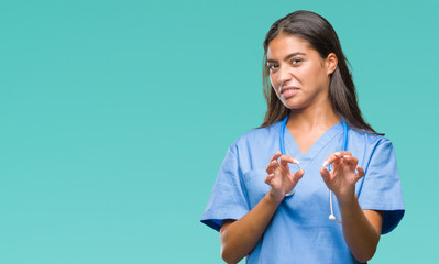 Young arab doctor surgeon woman over isolated background disgusted expression, displeased and...