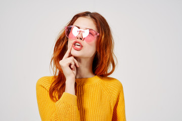 woman in a sweater and red glasses