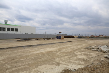 Fototapeta na wymiar The process of construction and launch of a large logistics center, its internal filling and finishing, the process of formation of the external territory and arrangement of warehouse and office space