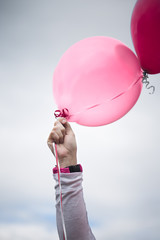 Woman Holding Up Pink Balloon