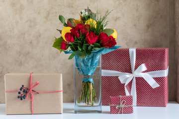a vase with flowers and gifts