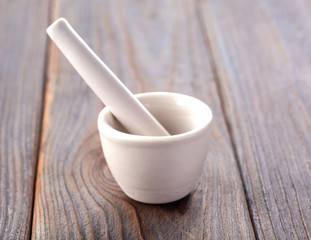 white empy mortar and pestles on old wooden background