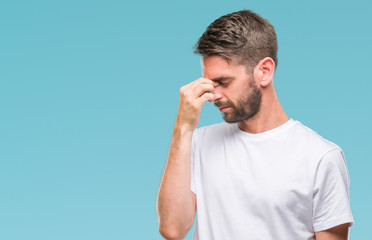 Young handsome man over isolated background tired rubbing nose and eyes feeling fatigue and headache. Stress and frustration concept.