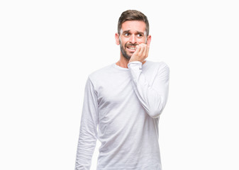 Young handsome man over isolated background looking stressed and nervous with hands on mouth biting nails. Anxiety problem.