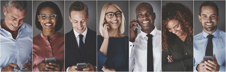 Diverse group of smiling business professionals using cellphones