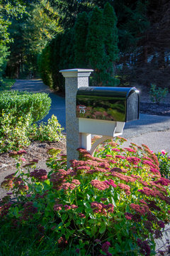 Granite Mailbox Post With Black Mailbox Showing Number 75 With Driveway In Beautiful Yard