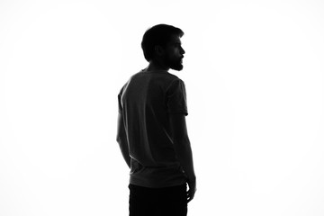 dark silhouette of a young man on a light background