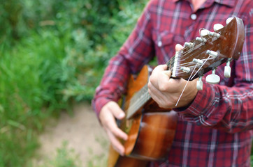 guitar in the hands of a musician close-up