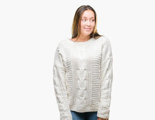 Young beautiful caucasian woman wearing winter sweater over isolated background smiling looking side and staring away thinking.