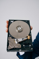Obraz premium unassembled hard drive in the hand of a business man