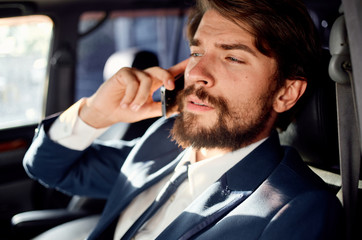 business man talking on the phone while driving