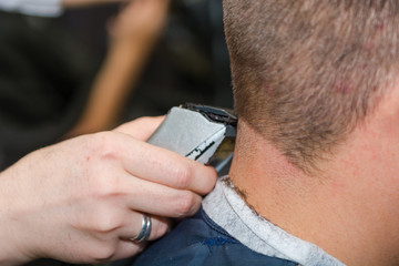 To shave hair to make a haircut for a man with a typewriter