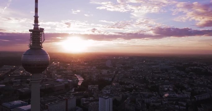 Aerial Shot of the TV Tower in Berlin, Germany. Circling Tower in a City with Pink Sky