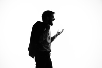 emotional man in the shadows with a jacket on his shoulder