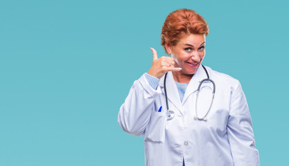 Senior caucasian doctor woman wearing medical uniform over isolated background smiling doing phone gesture with hand and fingers like talking on the telephone. Communicating concepts.