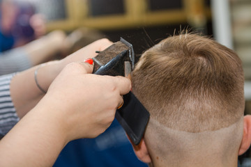 Make a fashionable haircut for children in the barbershop