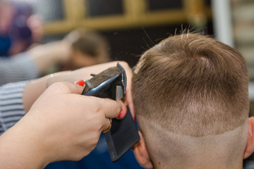 Make a fashionable haircut for children in the barbershop