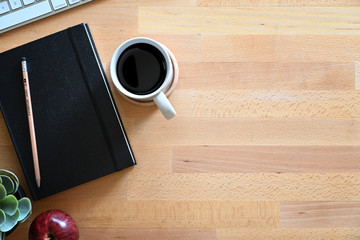 Notebook with keyboard computer on wooden workspace desk and copy space.