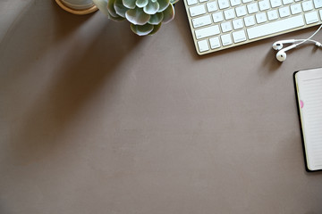 Brown desktop workspace with office supplies