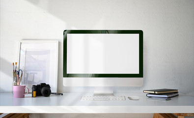 Minimal workspace desktop computer blank screen, poster and supplies