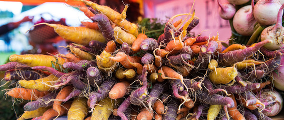 Stack of fresh organic carrots at farmers market