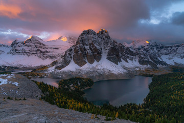 Alpenglow illuminates the sky and alpine peaks of the Canadian Rockies