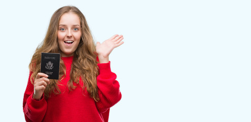 Young blonde woman holding passport of United States of America very happy and excited, winner expression celebrating victory screaming with big smile and raised hands