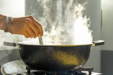 The boy's hands are cooking in the morning.