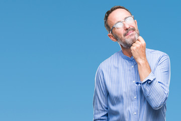 Middle age hoary senior man wearing glasses over isolated background with hand on chin thinking about question, pensive expression. Smiling with thoughtful face. Doubt concept.