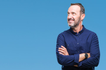 Middle age hoary senior man over isolated background smiling looking side and staring away thinking.