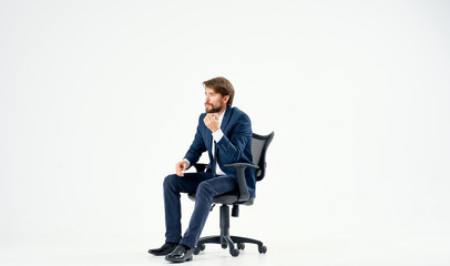 man in a suit sitting in a chair