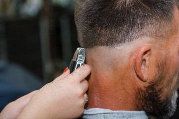 To shave hair to make a haircut for a man with a typewriter