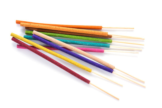 Closeup of colorful incense sticks isolated on white background