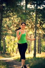 Young beautiful girl doing physical exercises in a park. Summer season