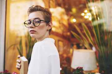woman in glasses with a book in her hands
