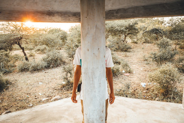 Boy hiding behind the pillar
