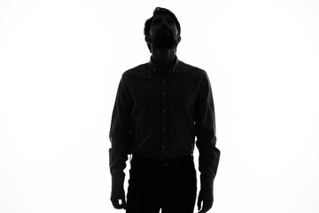 man in the shadows looks up