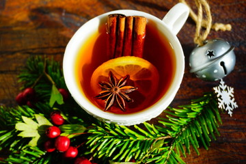 Hot tea  with spices on a wooden background. Selective focus.Still life, food and drink, seasonal and holidays concept.
