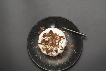 Pavlova meringue cake with cream chocolate and nuts.