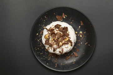 Pavlova meringue cake with cream chocolate and nuts.