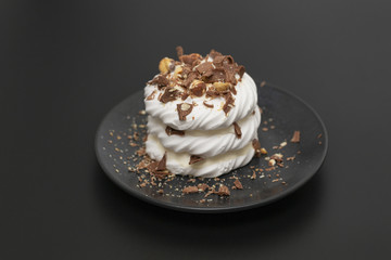 Pavlova meringue cake with cream chocolate and nuts.