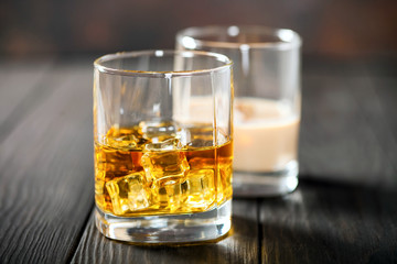 Whisky with ice and a lemon and creamy liqueur with chocolate