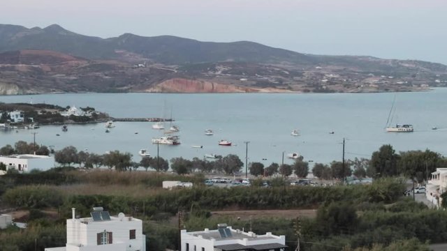 Boats enter harbor in Pollonia, Milos, Greece