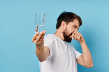 man turning away holding a glass of water