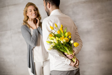 Man giving bouquet of yellow tulips to his girlfriend